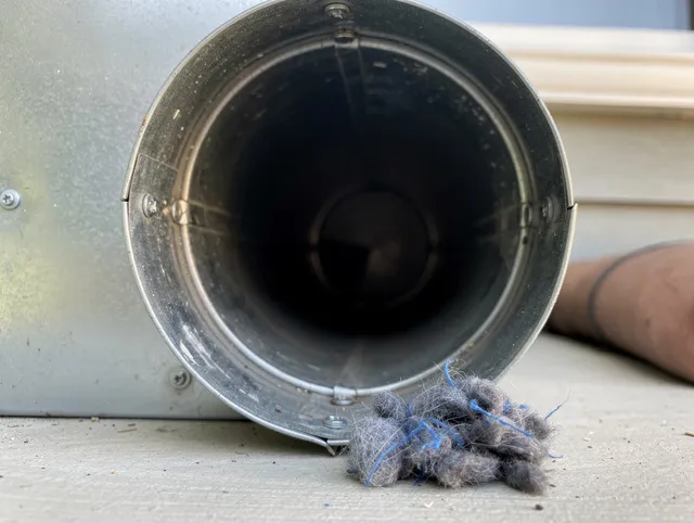 San Fernando Dryer Vent Cleaning technician using specialized equipment to clear severe dryer vent blockage in San Fernando